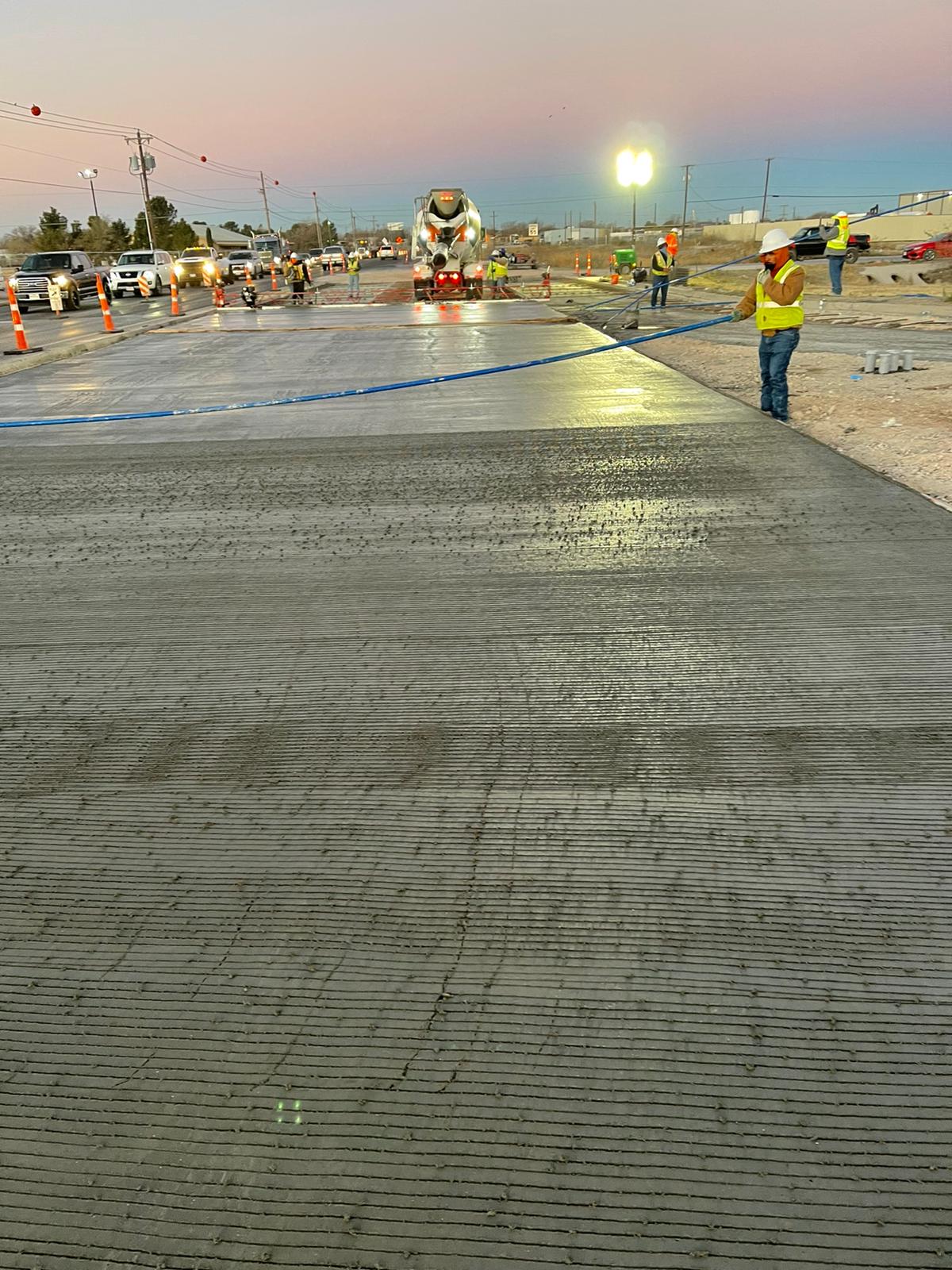 Fresh concrete roadway paving at dusk
