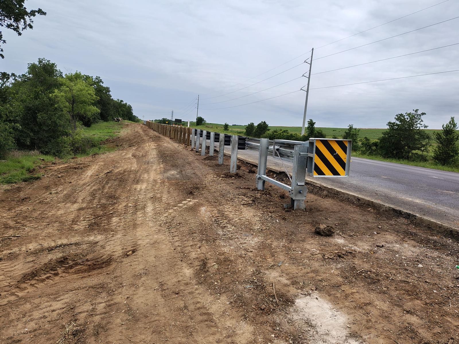 Long run of guardrail installed beside an active roadway