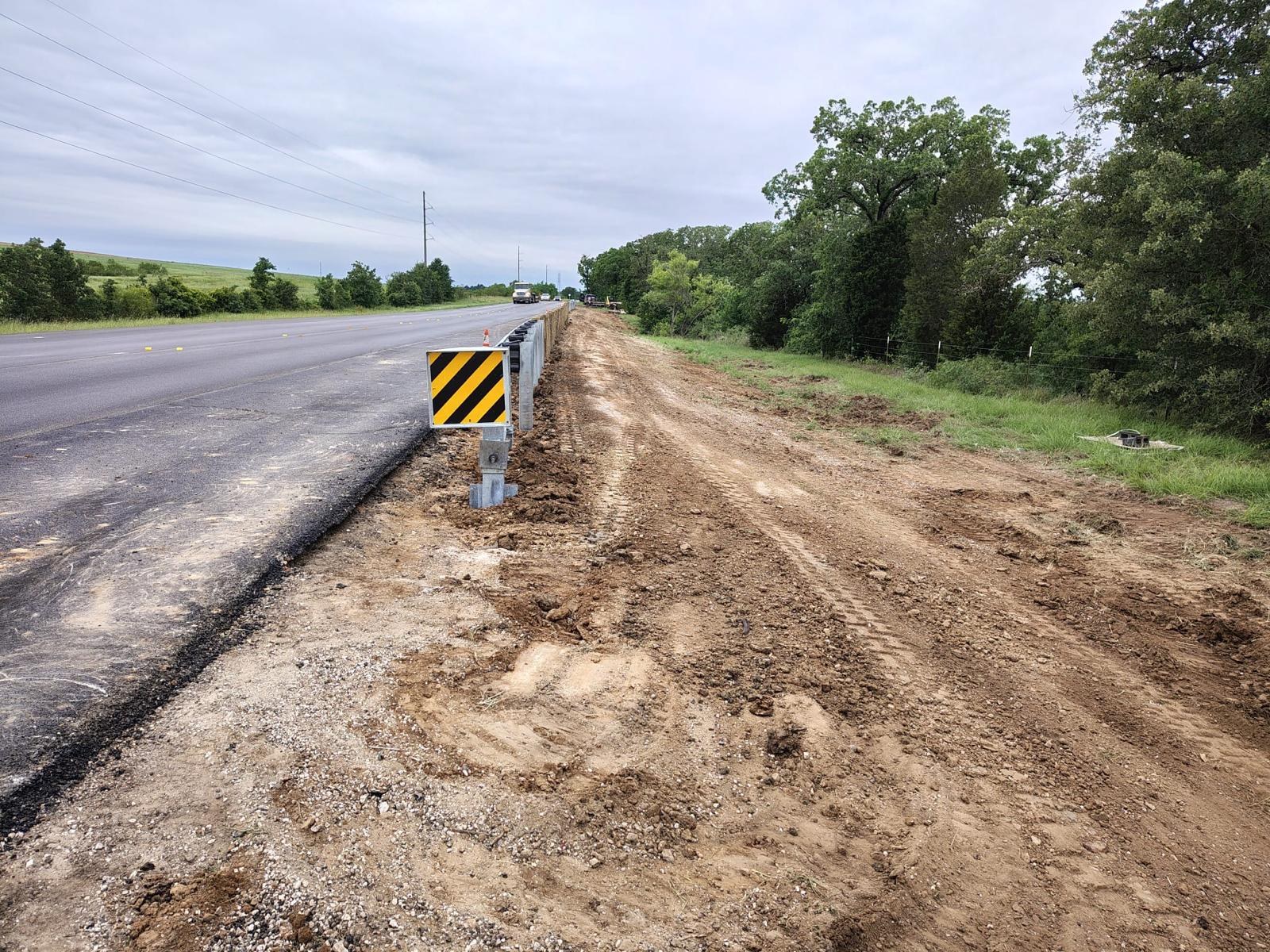 Highway guardrail run and terminal installed along a Texas roadway